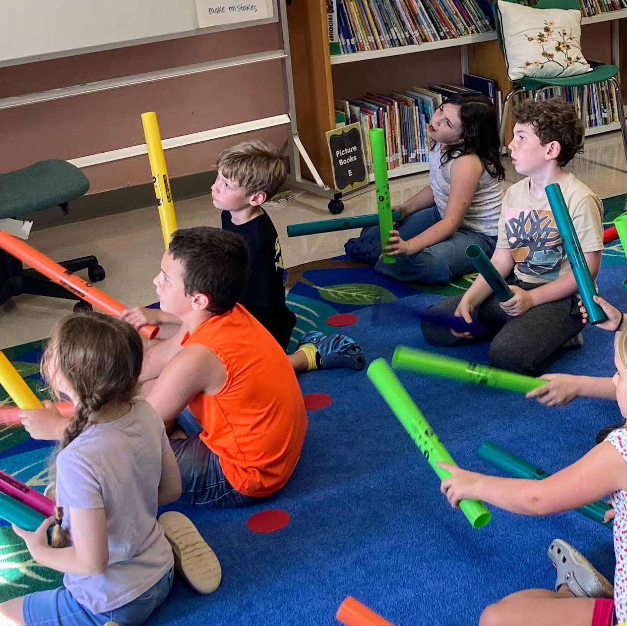 Students play the boomsticks in music class.